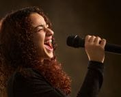 Professional female singer with microphone.