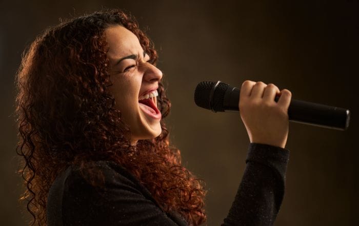 Professional female singer with microphone.